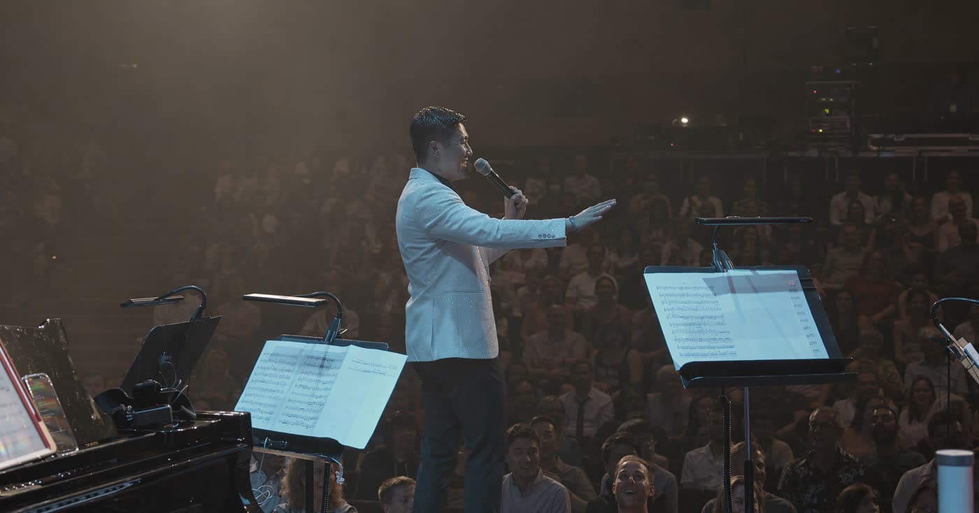 Lionel Yu addressing the audience from the stage